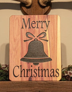 Wooden cedar Christmas sign with black bell and 'Merry Christmas' text.